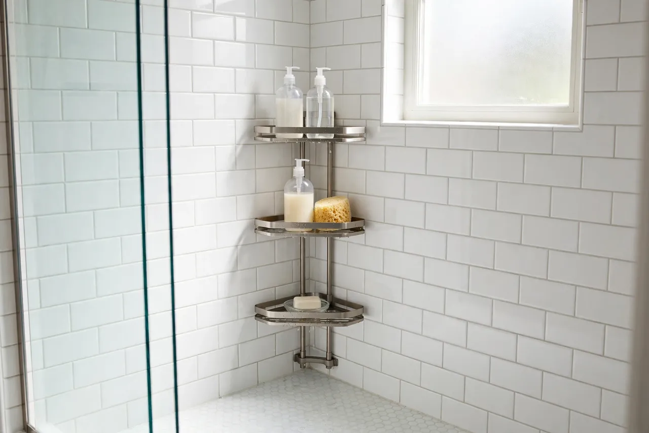 Rustproof corner shower caddy with bottles in a bright white shower